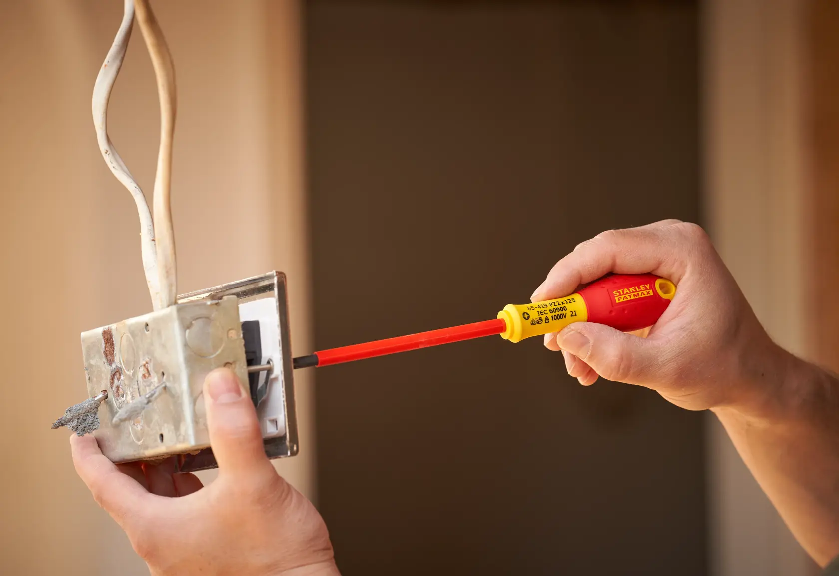 Foto des STANLEY 0-65-419 isolierten Schraubendrehers bei der Arbeit an einer elektrischen Schalterdose.