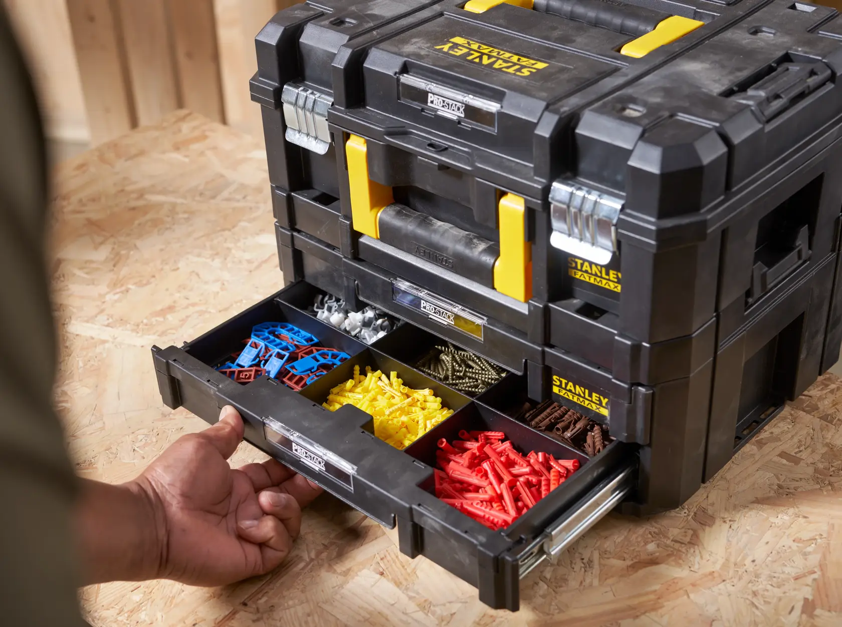STANLEY FMST1-71981 Organizerbox mit offener Schublade und sortiertem Befestigungsmaterial, schwarz-gelb, Frontansicht.