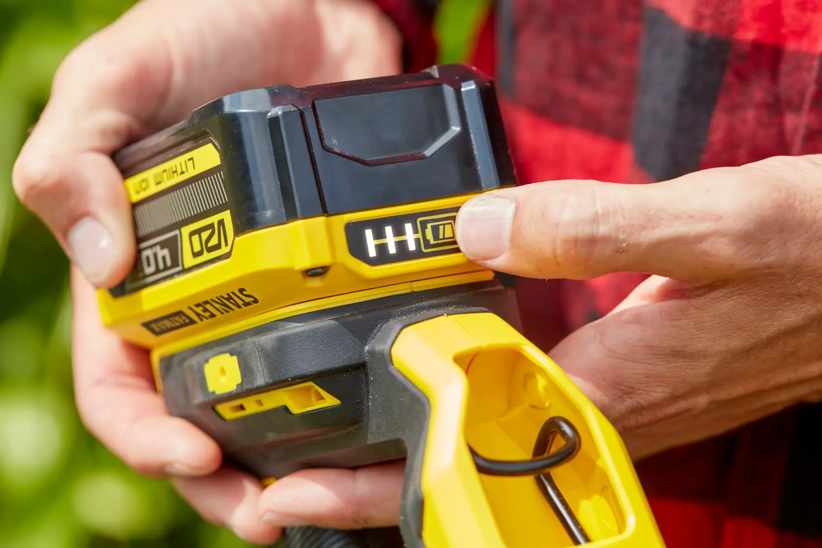 Foto der STANLEY SFMCST933B Akku-Werkzeugbatterie im Nahaufnahme, mit Ladeanzeige und gelbem Griff.