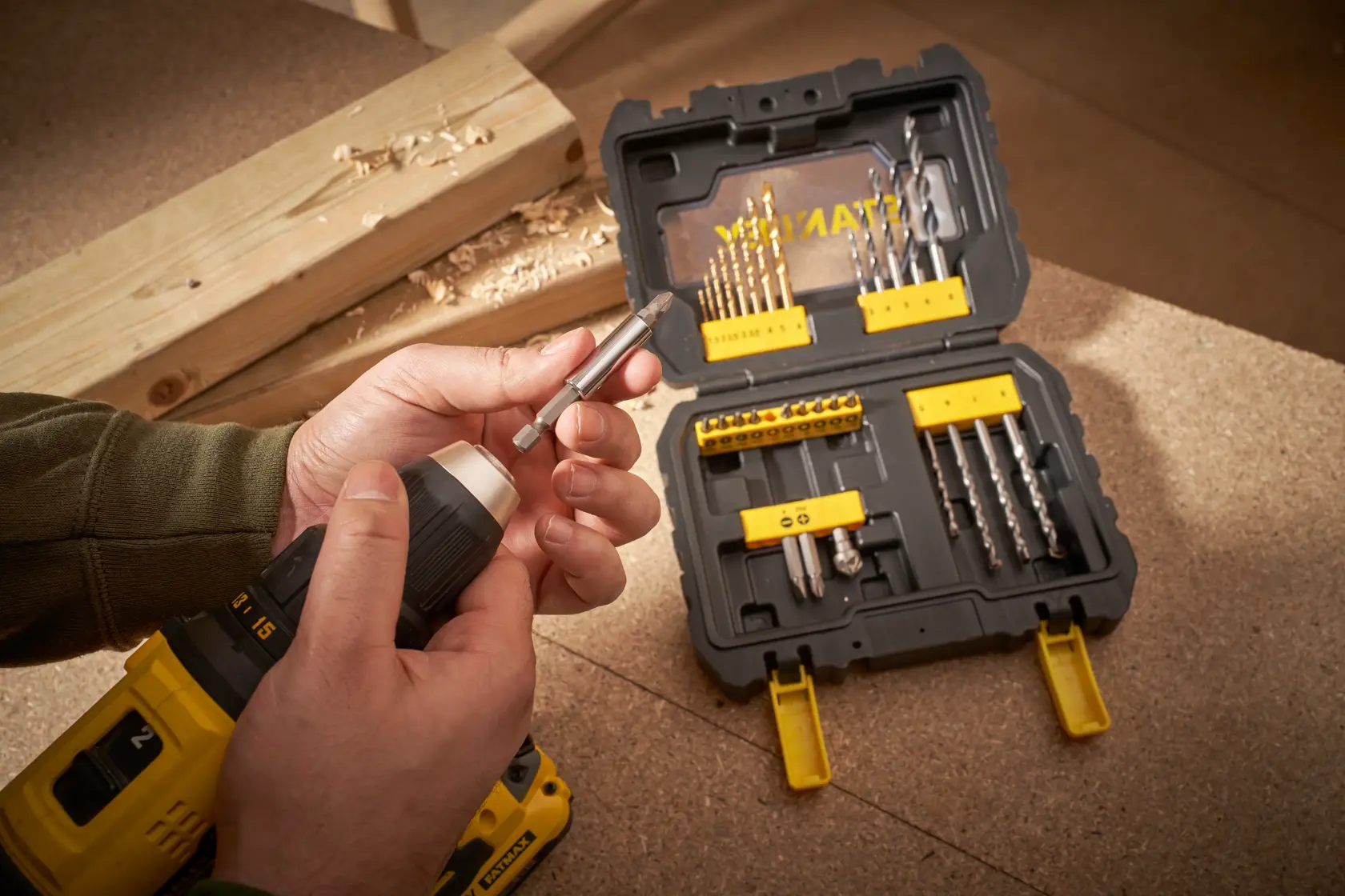 Foto des STANLEY STA88550 Bohrer-Sets in schwarzem und gelbem Koffer mit verschiedenen Bits auf Werkbank.