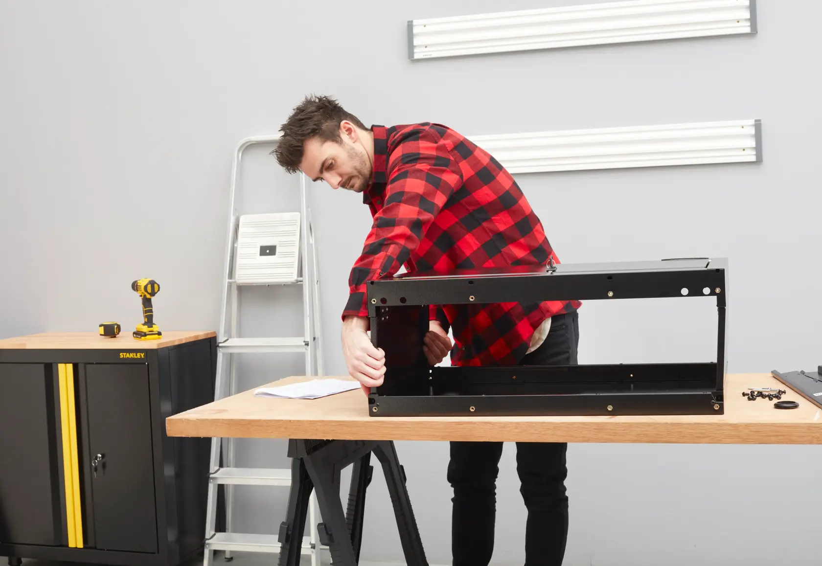 STANLEY STST97599-1 Schrankmontage in Werkstatt mit Werkzeugen und Holz-Werkbank.